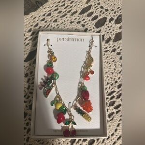 Viral persimmon glass and gemstone gold tone charm necklace